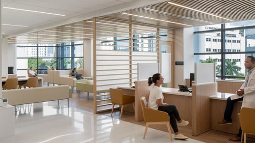 a patient speaks with medial staff in the reception area of a cancer research building